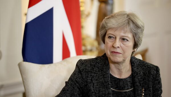 British Prime Minister Theresa May listens at the start of her meeting with the Emir of Qatar Tamim bin Hamad Al Thani inside 10 Downing Street in London, Tuesday, July 24, 2018 - Sputnik Moldova-România