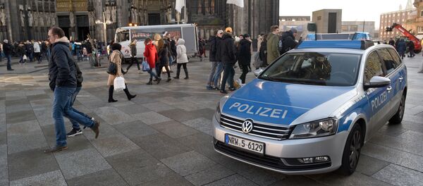 A police car drives past the Cologne Cathedral near the station square on December 30, 2016 in Cologne, western Germany. A police car drives past the Cologne Cathedral near the station square on December 30, 2016 in Cologne, western Germany. - Sputnik Moldova-România