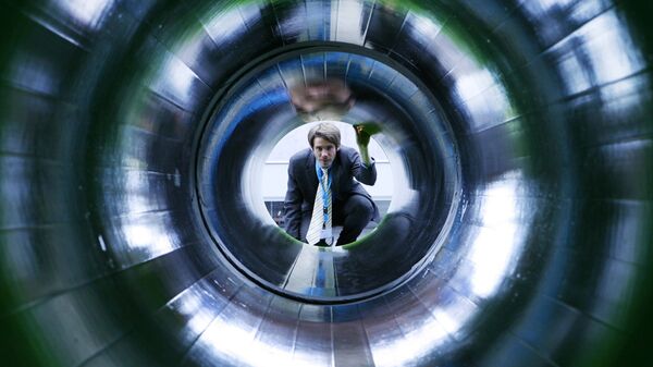 A man looks into a tube representing a natural gas pipeline at the booth of Nord Stream at the Hanover industrial fair in Hanover, Germany (File) - Sputnik Moldova