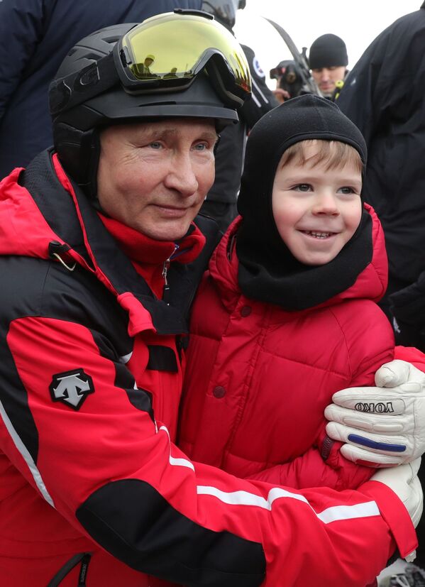 Президент РФ Владимир Путин фотографируется с ребенком во время катания на лыжах в Сочи - Sputnik Молдова