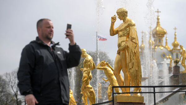 Турист фотографирует у фонтанов Большого каскада во время весеннего открытия в Государственном музее-заповеднике Петергоф - Sputnik Молдова