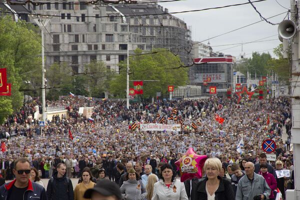 А колонна шествия, кажется, не иссякает - так много тех, кто считает своим долгом почтить память и таким образом поблагодарить своих предков за Победу. - Sputnik Молдова