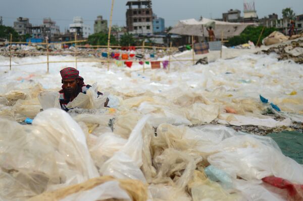 Мужчина сортирует пластик в Дакке, Бангладеш - Sputnik Молдова
