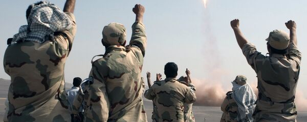 In this photo released by the Islamic Republic News Agency (IRNA), members of the Iranian Revolutionary Guard celebrate after launching a missile during their maneuver in an undisclosed location in Iran (File) - Sputnik Moldova