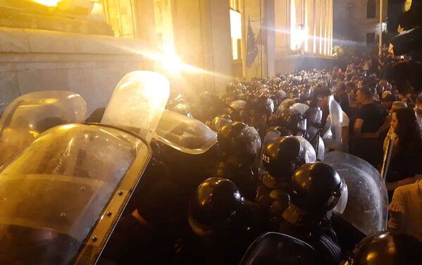 Сотрудники полиции и участники акции протеста у здания парламента Грузии в Тбилиси - Sputnik Молдова