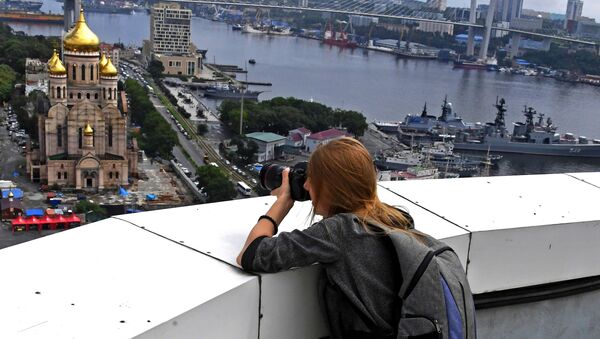 Девушка фотографирует с крыши высотного здания администрации Приморского края во Владивостоке - Sputnik Moldova-România