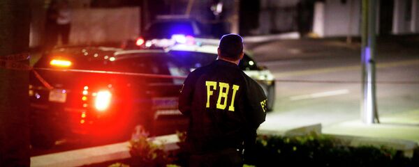 An FBI agent walks across the street from the Emanuel AME Church following a shooting Wednesday, June 17, 2015, in Charleston, S.C. - Sputnik Moldova-România