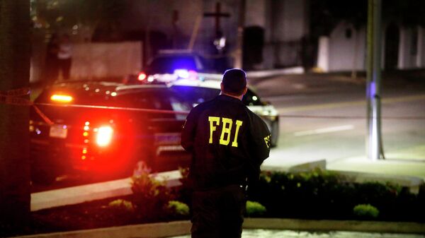 An FBI agent walks across the street from the Emanuel AME Church following a shooting Wednesday, June 17, 2015, in Charleston, S.C. - Sputnik Moldova-România
