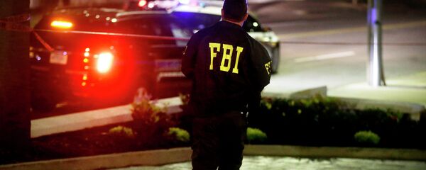 An FBI agent walks across the street from the Emanuel AME Church following a shooting Wednesday, June 17, 2015, in Charleston, S.C. - Sputnik Moldova