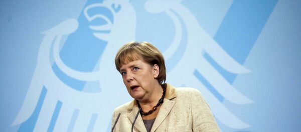 German Chancellor Angela Merkel  in front of Germany's heraldic eagle - Sputnik Moldova