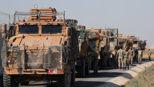 Turkish soldiers stand near military trucks in the village of Yabisa, near the Turkish-Syrian border, Syria, October 12, 2019. REUTERS/Khalil Ashawi - Sputnik Moldova-România