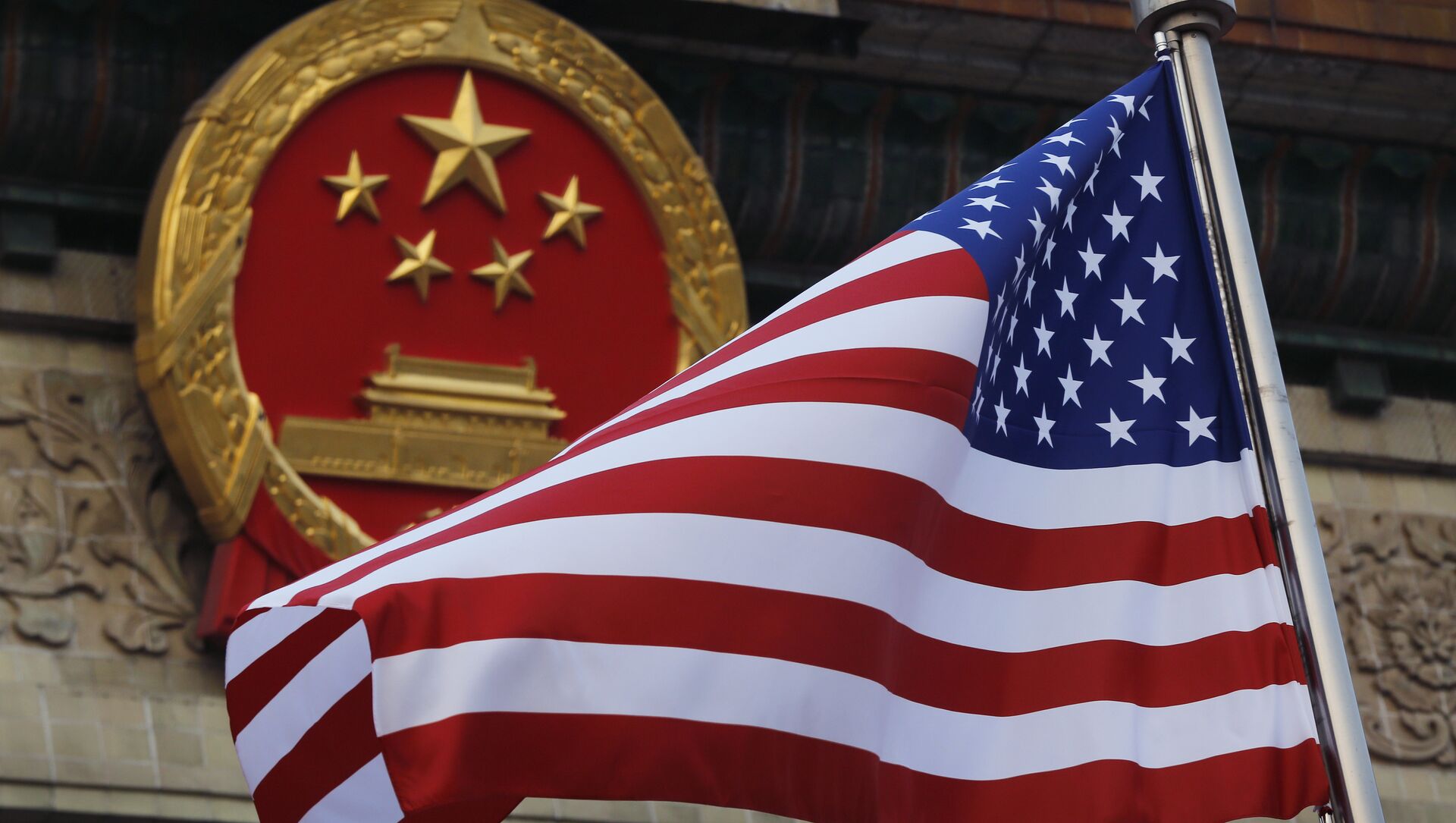FILE - In this Nov. 9, 2017 file photo, an American flag is flown next to the Chinese national emblem during a welcome ceremony for visiting U.S. President Donald Trump outside the Great Hall of the People in Beijing - Sputnik Moldova-România, 1920, 19.05.2021