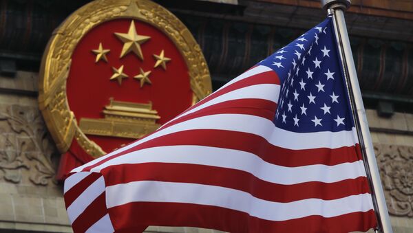 FILE - In this Nov. 9, 2017 file photo, an American flag is flown next to the Chinese national emblem during a welcome ceremony for visiting U.S. President Donald Trump outside the Great Hall of the People in Beijing - Sputnik Moldova