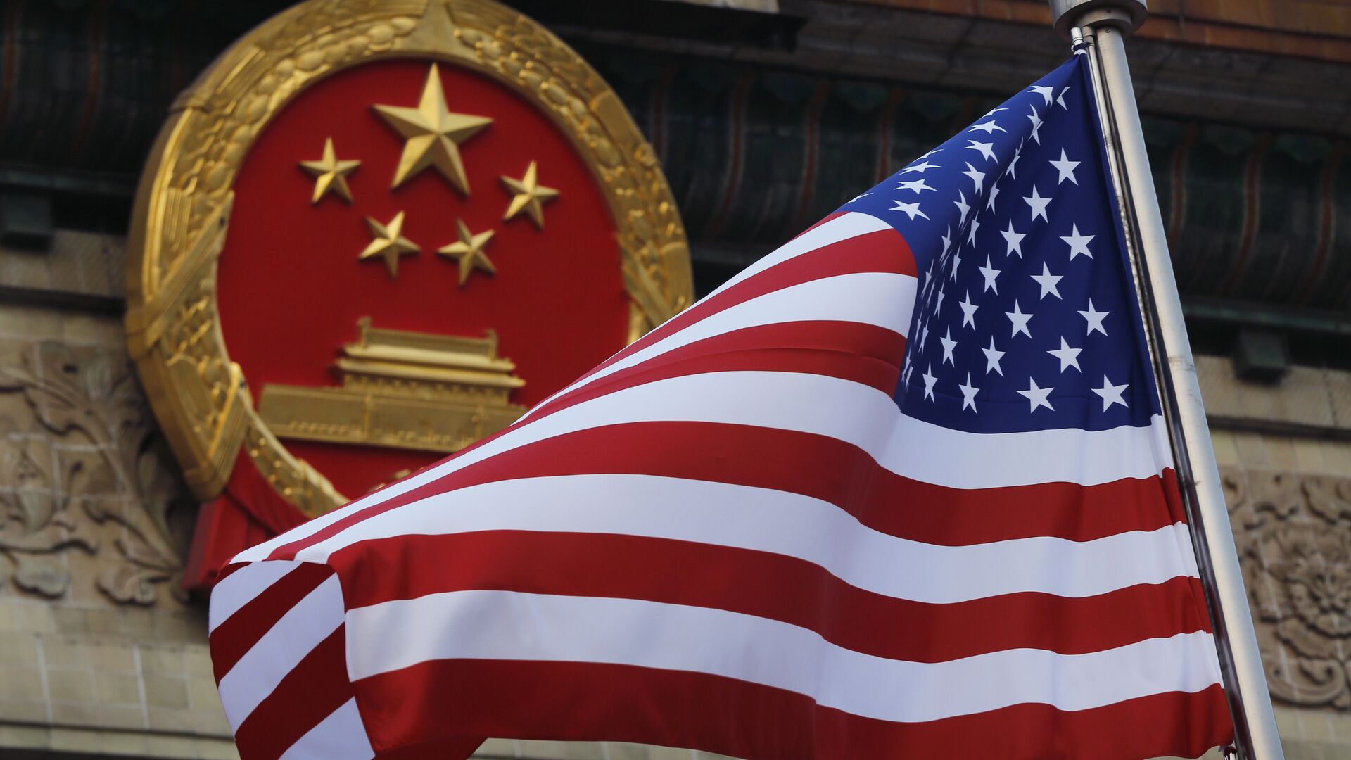 FILE - In this Nov. 9, 2017 file photo, an American flag is flown next to the Chinese national emblem during a welcome ceremony for visiting U.S. President Donald Trump outside the Great Hall of the People in Beijing - Sputnik Moldova, 1920, 29.08.2023