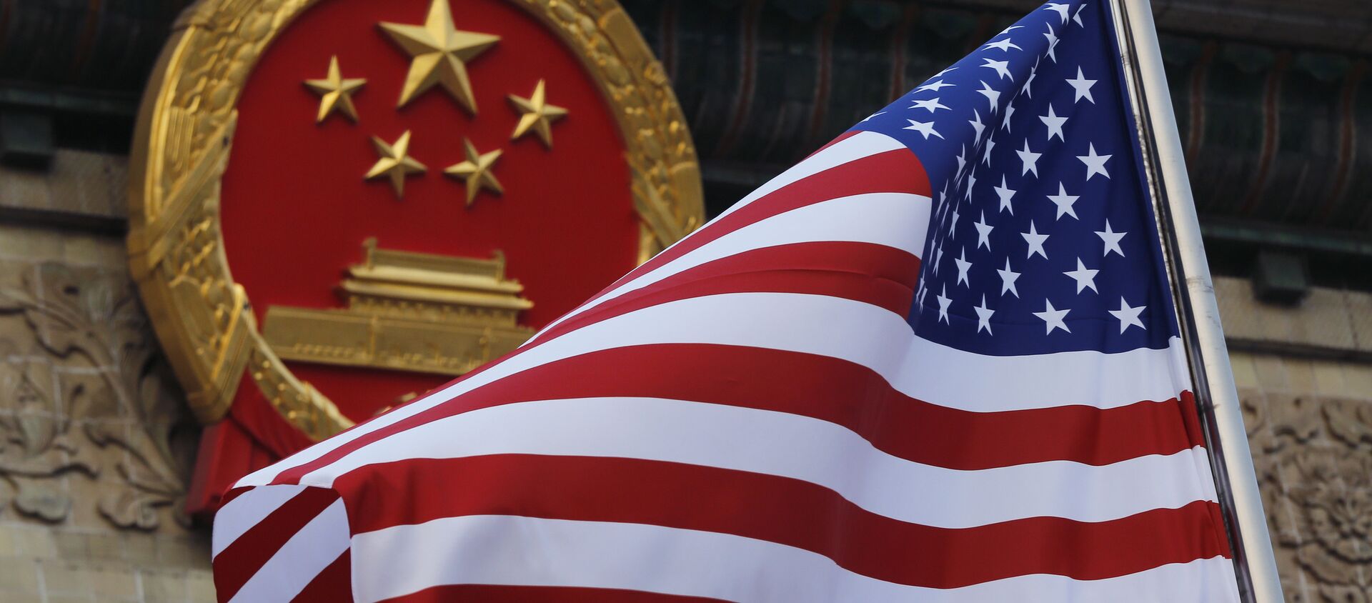 FILE - In this Nov. 9, 2017 file photo, an American flag is flown next to the Chinese national emblem during a welcome ceremony for visiting U.S. President Donald Trump outside the Great Hall of the People in Beijing - Sputnik Moldova-România, 1920, 14.06.2021