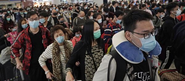 Пассажиры в защитных масках на железнодорожном вокзале Гонконга - Sputnik Молдова
