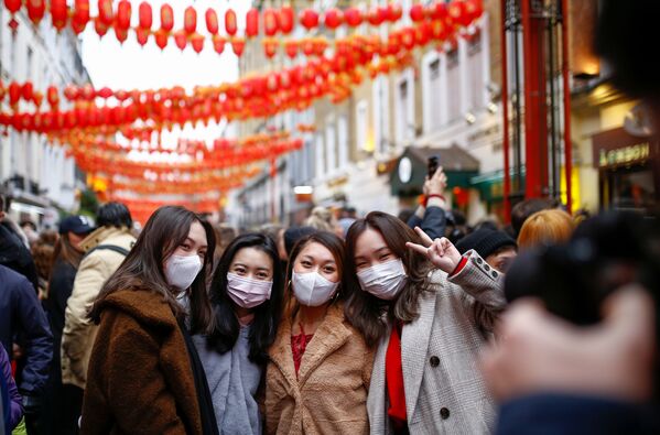 Люди в медицинских масках во время празднования Китайского нового года в районе Чайна-таун в Лондоне - Sputnik Moldova-România