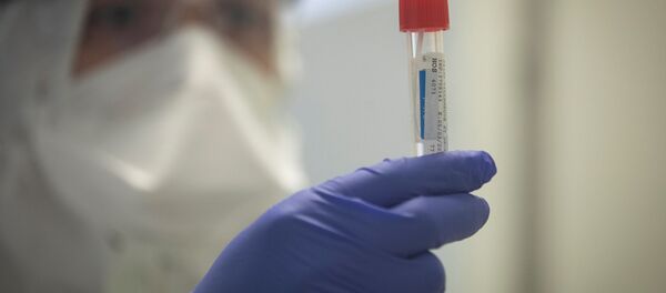 Un operator de laborator efectuează teste pe probe posibil infectate cu Covid-19 - Sputnik Moldova