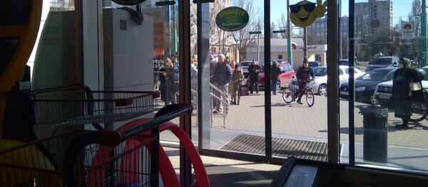 Cumpărătorii așteaptă în fața unui supermarket din capitală - Sputnik Moldova