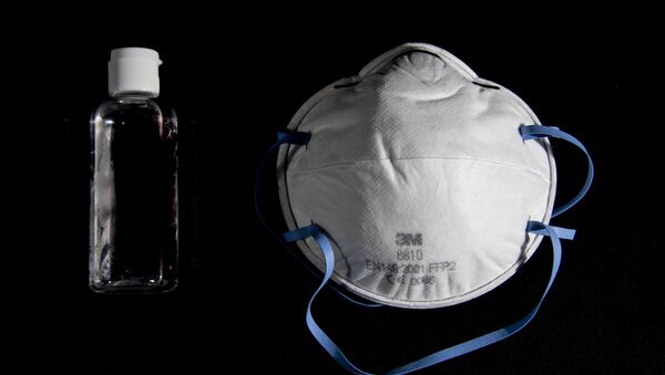  Бутылка дезинфицирующего средства для рук с спиртосодержащим гелем и защитная маска для лица  - Sputnik Молдова