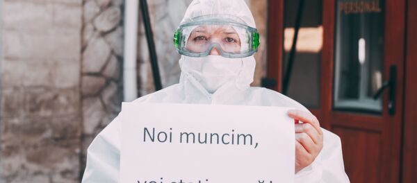 Медицинский работник в маске с обращением к гражданам Noi muncim, voi stați acasă! - Sputnik Молдова