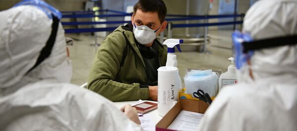 Медицинские работники во время проверки состояния пассажира в аэропорту Внуково - Sputnik Moldova