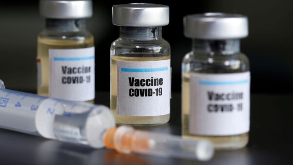 Маленькие бутылочки с наклейкой «Vaccine COVID-19» и медицинский шприц - Sputnik Moldova-România