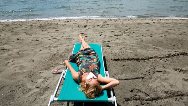 Девушка загорает на пляже в Италии - Sputnik Moldova-România