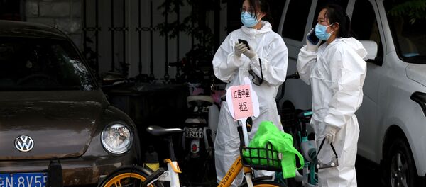 Люди в защитных костюмах у места проведения тестирования на наличие коронавируса в Пекине  - Sputnik Moldova-România