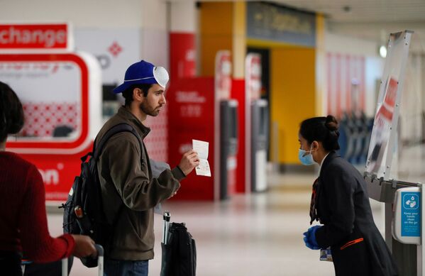 Пассажир предъявляет свой паспорт сотруднику в аэропорту Гатвик, Великобритания - Sputnik Молдова