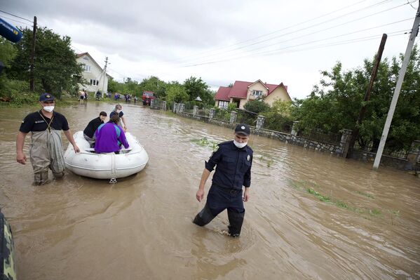 Сотрудники МЧС Украины эвакуируют жителей затопленного села Ланчин в Ивано-Франковской области - Sputnik Moldova-România