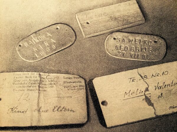 Бирки для детей, отнятых у родителей. На них носились имя, фамилия, возраст ребенка. Дети, играя бирками, часто путали их. - Sputnik Молдова