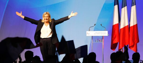 France’s far-right National Front president Marine Le Pen, center, surrounded by members, waves to supporters after her speech during their meeting in Marseille, southern France, Saturday, Sept. 6, 2015. - Sputnik Moldova-România