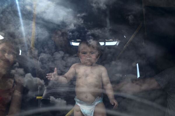 Ребенок в салоне автобуса на пограничном пункте пропуска Изварино в Луганской области - Sputnik Молдова