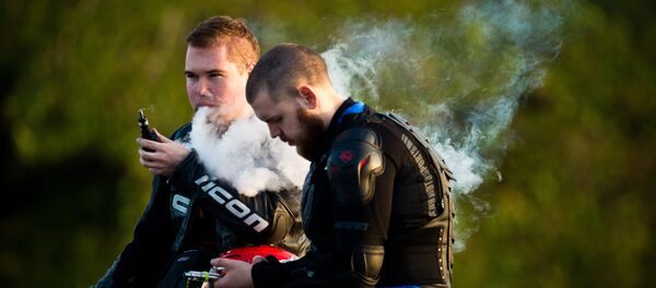 Молодые люди курят электронные сигареты. - Sputnik Молдова
