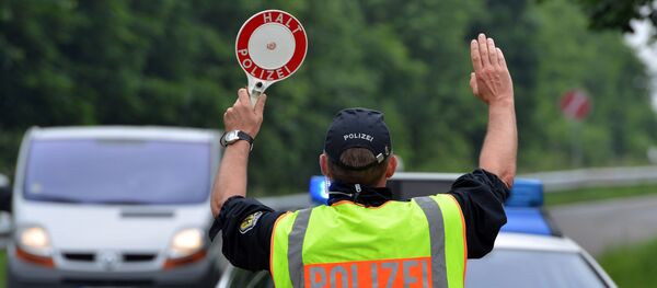 Members of the German Federal Police seen next to a police vehicle during traffic checks on a car park along the A 64 motorway near Trier, Germany, Sunday June 12, 2016. Members of the German Federal Police seen next to a police vehicle during traffic checks on a car park along the A 64 motorway near Trier, Germany, Sunday June 12, 2016. - Sputnik Moldova-România