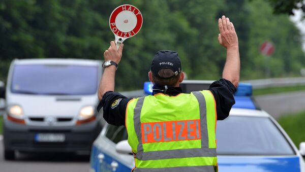 Members of the German Federal Police seen next to a police vehicle during traffic checks on a car park along the A 64 motorway near Trier, Germany, Sunday June 12, 2016. - Sputnik Moldova-România