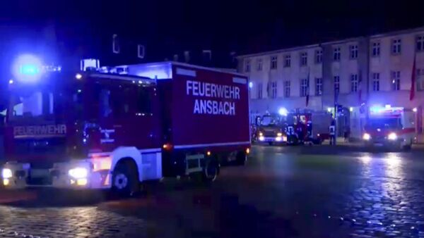 In this image taken from video fire trucks and ambulances stand in the city center of Ansbach near Nuremberg, southern Germany, Monday morning, July 25, 2016, after a man was killed when an explosive device he was believed to be carrying went off near an open-air music festival, injuring 12 others. - Sputnik Moldova
