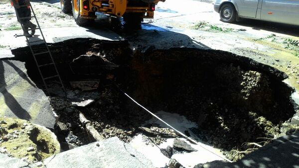 O bucată de asfalt de pe o stradă din centrul Chişinăului s-a surpat, creând un adevărat pericol pentru pietoni şi conducătorii auto. - Sputnik Молдова