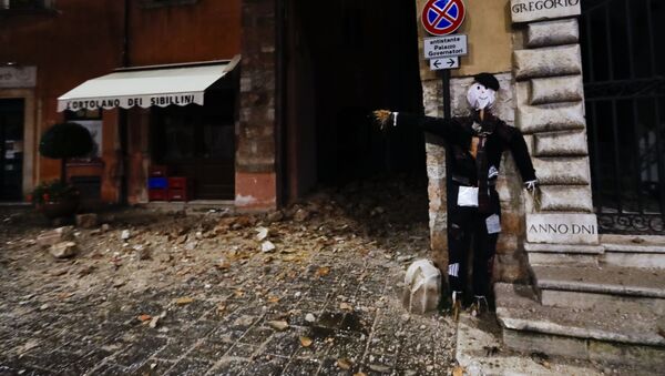 An Halloween dummy rests on a wall in the town of Visso in central Italy, early Thursday, Oct 27, 2016, after a 5.9 earthquake hit the area - Sputnik Молдова